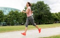 Woman with earphones running at park Royalty Free Stock Photo
