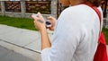 Woman in earphones on street, going to work luxury city area, gadget technology