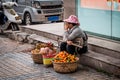 Woman in Eastern dress selling fruit