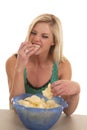Woman eat chips from bowl