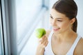 Woman Eating Apple. Beautiful Girl With White Teeth Biting Apple