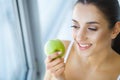 Woman Eating Apple. Beautiful Girl With White Teeth Biting Apple Royalty Free Stock Photo