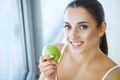 Woman Eating Apple. Beautiful Girl With White Teeth Biting Apple Royalty Free Stock Photo