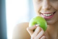 Woman Eating Apple. Beautiful Girl With White Teeth Biting Apple Royalty Free Stock Photo