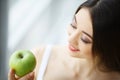 Woman Eating Apple. Beautiful Girl With White Teeth Biting Apple Royalty Free Stock Photo