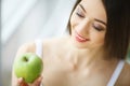 Woman Eating Apple. Beautiful Girl With White Teeth Biting Apple Royalty Free Stock Photo