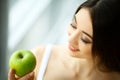 Woman Eating Apple. Beautiful Girl With White Teeth Biting Apple Royalty Free Stock Photo