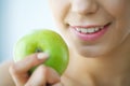 Woman Eating Apple. Beautiful Girl With White Teeth Biting Apple Royalty Free Stock Photo