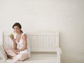 Woman Eating Apple On Bench Royalty Free Stock Photo