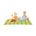 Woman Eating Apple And Man Reading Newspaper On Picnic