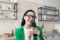 A woman eating a bar of dark chocolate. Standing at home in the kitchen, eyes closed, enjoying Royalty Free Stock Photo