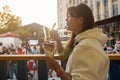 woman eating Belgian french fries with sauce at food court. street food festival Royalty Free Stock Photo