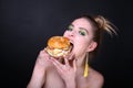 Woman eating big hamburger