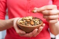 Close Up Of Woman Eating Bowl Of Healthy Nuts And Seeds Royalty Free Stock Photo