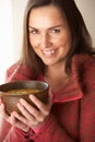 Woman eating bowl of soup