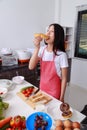 Woman eating a bread in kichen room
