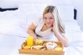 Woman eating breakfast in bed Royalty Free Stock Photo