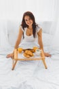 Woman eating breakfast in bed Royalty Free Stock Photo