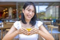 Woman eating Breakfast. Fruits such as watermelon, papaya, melon, passion fruit, orange juice and coffee. placed on a gray