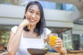 Woman eating Breakfast. Fruits such as watermelon, papaya, melon, passion fruit, orange juice and coffee. placed on a gray