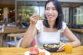 Woman eating Breakfast. Fruits such as watermelon, papaya, melon, passion fruit, orange juice and coffee. placed on a gray