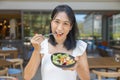 Woman eating Breakfast and play smart phone. Fruits such as watermelon, papaya, melon, passion fruit, orange juice and coffee. Royalty Free Stock Photo