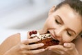 Woman Eating Cake. Beautiful Female Eating Dessert Royalty Free Stock Photo