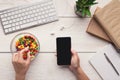 Woman eating candies at workplace, top view Royalty Free Stock Photo