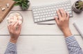 Woman eating candies at workplace, top view Royalty Free Stock Photo