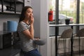 Young woman eating cherries in hostel kitchen Royalty Free Stock Photo