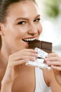 Woman Eating Chocolate. Beautiful Girl With Sweets. Royalty Free Stock Photo