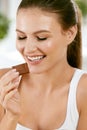 Woman Eating Chocolate. Beautiful Girl With Sweets. Royalty Free Stock Photo