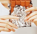 Woman eating chocolate, close up hands with Royalty Free Stock Photo