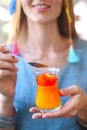 Woman eating citrus cumquat jelly dessert