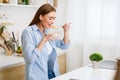 Woman Eating Corn Flakes Having Breakfast In Kitchen