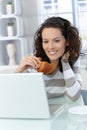 Woman eating croissant Royalty Free Stock Photo