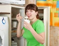 Woman eating dairy cream from fridge