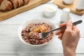 Woman eating delicious brown rice at white table, closeup Royalty Free Stock Photo