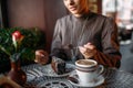 Woman eating delicious chocolate cake in cafe