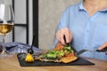 Woman eating delicious grilled fish with vegetables at table, closeup Royalty Free Stock Photo