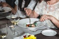 Woman eating delicious salmon pasta in a restaurant. small portion