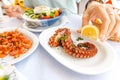 woman eating delicious seafood - shrimp and octopus grilled and vegetable salad. The concept of Mediterranean Royalty Free Stock Photo