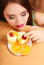 Woman eating delicious sweet cake. Gluttony. Royalty Free Stock Photo