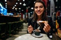 Woman eating deseert with chocolate.Craving for sweet and carbs.Breaking the diet.Happy tourist enoying traditional fried dough Royalty Free Stock Photo