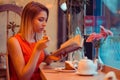 Woman eating dessert while reading a book in a trendy cafe Royalty Free Stock Photo