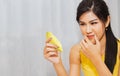 Woman eating durian Popular tropical fruits at night : Beautiful young woman holding sweet smelling yellow durian Looking at it wi