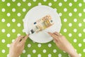 Woman eating fifty euroes banknotel for dinner Royalty Free Stock Photo