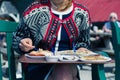 Woman eating fish and cockles outside