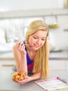 Woman eating fruits salad in kitchen Royalty Free Stock Photo