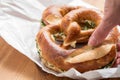 Woman eating German Brezel pretzel with chives and butter